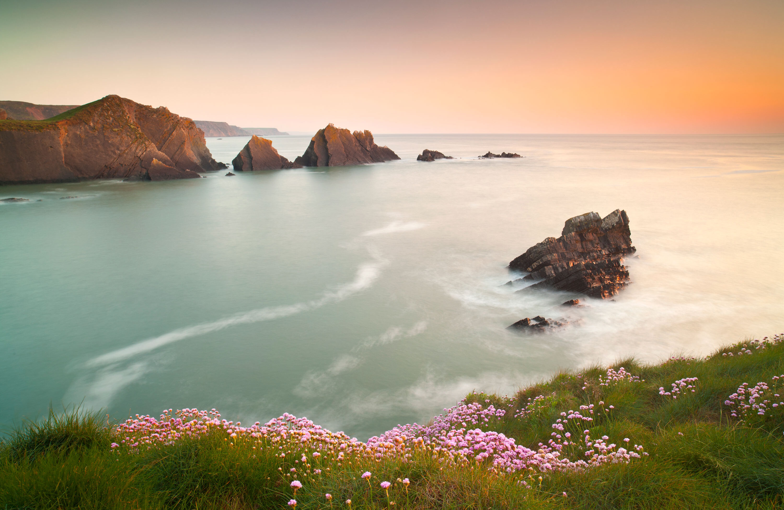 Hartland Quay with a view of the sea and cliffs at sunset