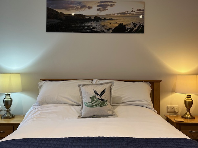 A double bed in a bedroom at the Hartland Quay Hotel