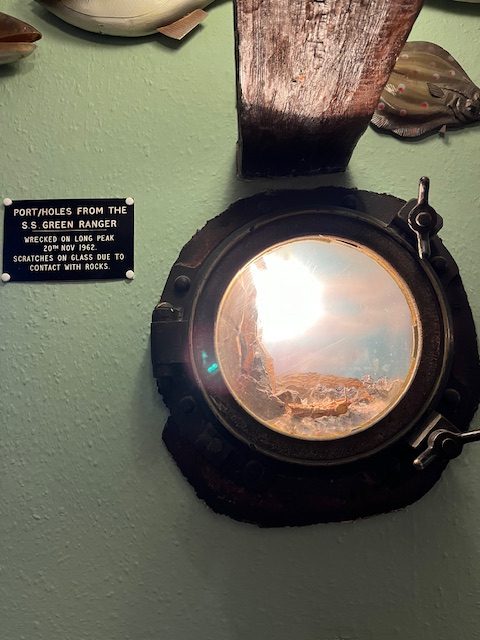 A porthole from a shipwreck on the wall of The Wreckers Retreat