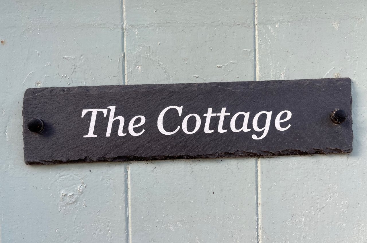 Door Sign reading The Cottage