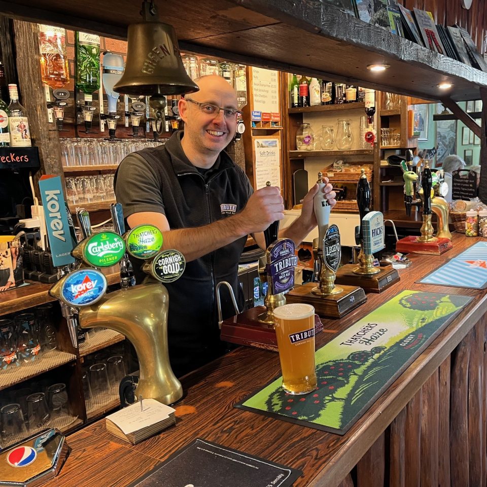 Barman pulling pint of bitter at the Wreckers Retreat Bar at Hartland Quay