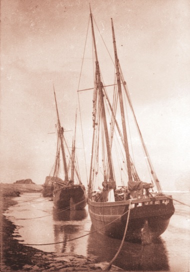 Vintage sepia tone picture of ships docked at Hartland Quay